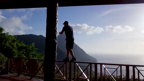 a man dances on the balcony of a hotel at a resort on the caribbean island of st lucia