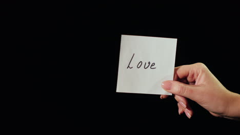 man burns a paper with the inscription love