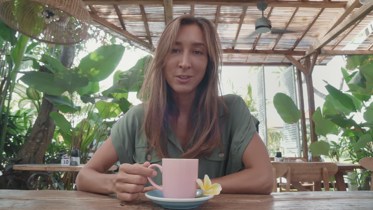 Woman Talking on Camera in Outdoor Cafe