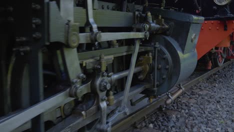 closeup shot of steam locomotive wheels and pistons