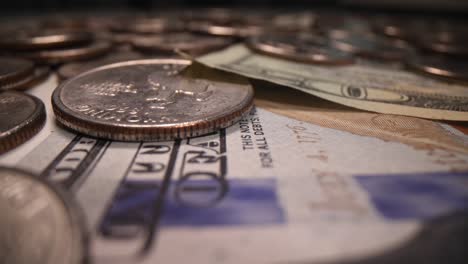 american dollar bills and coins in dark background