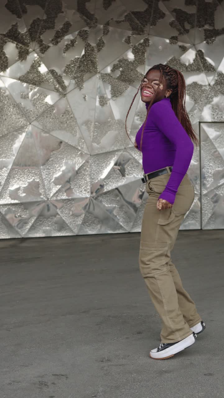 A woman dancing in an urban setting