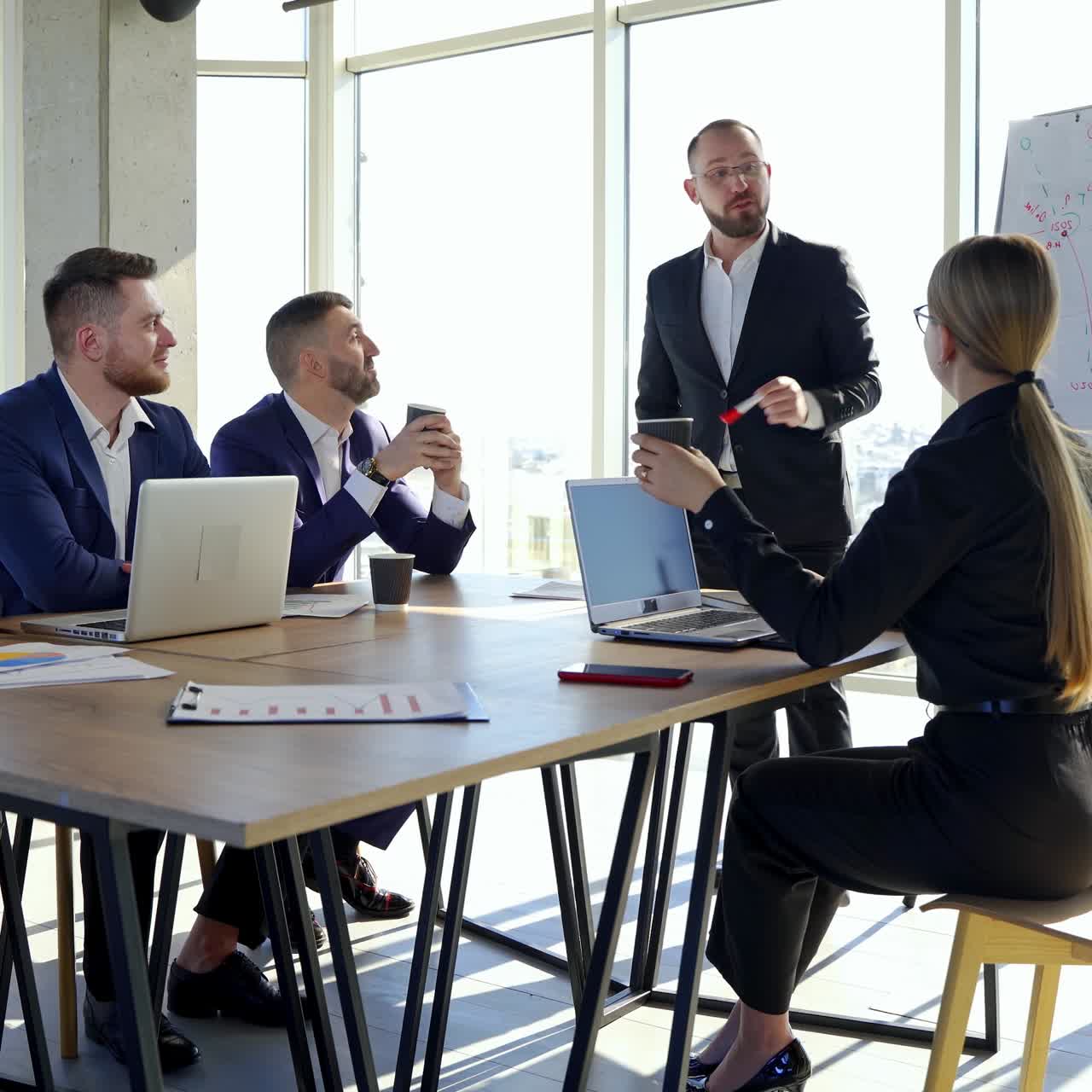Happy business team discussing together at office meeting with laptop. Brainstorming at the office