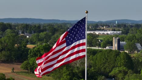 majestic american flag waving in wind, aerial rising