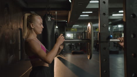 side view of caucasian woman female monitor in the gym.