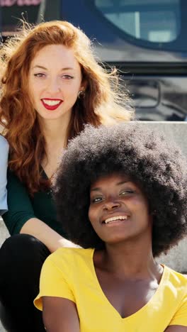 two diverse women smiling happily outdoors
