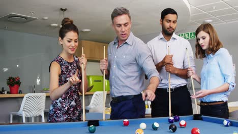 Executives-playing-pool-in-office