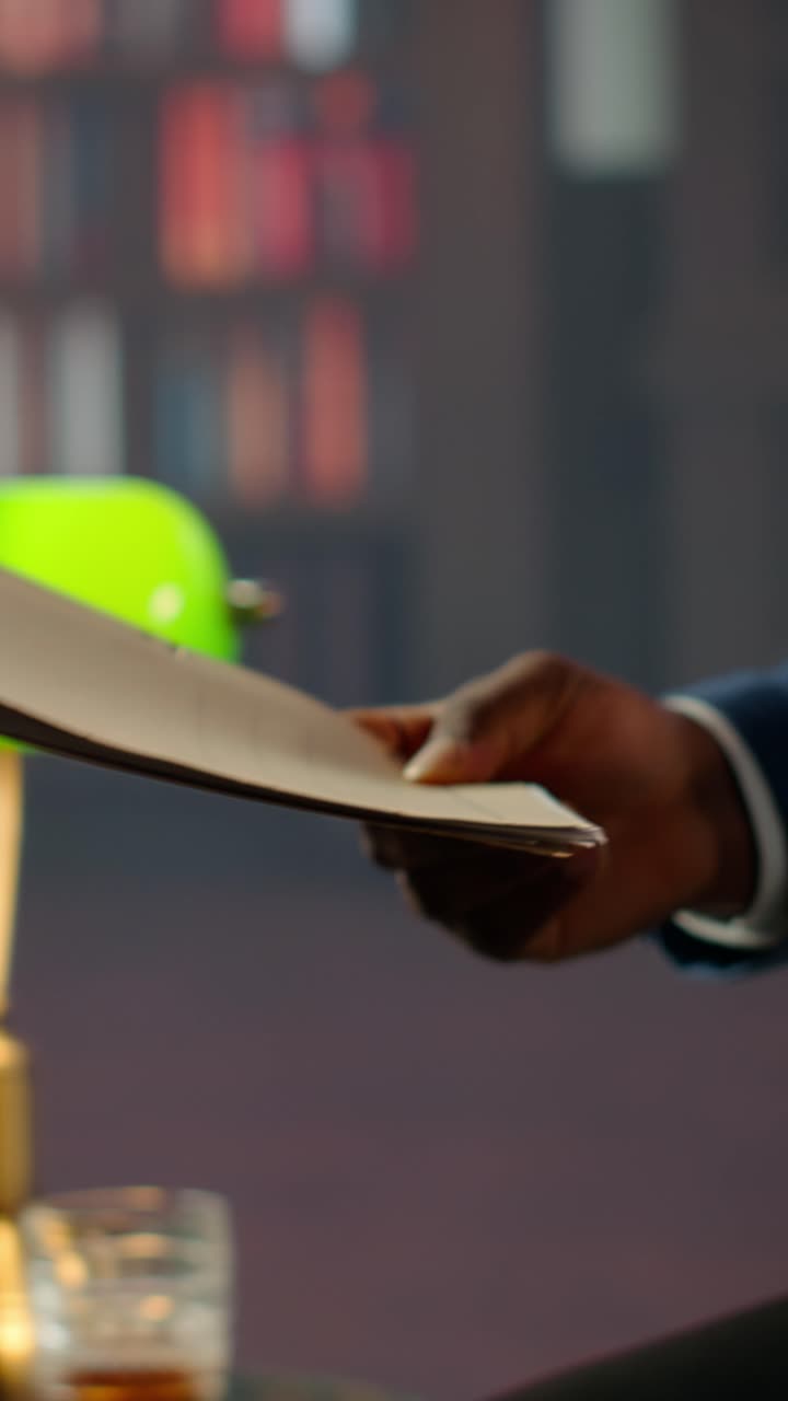 Close Up of Person's Hands Flipping Through Documents in File Folder