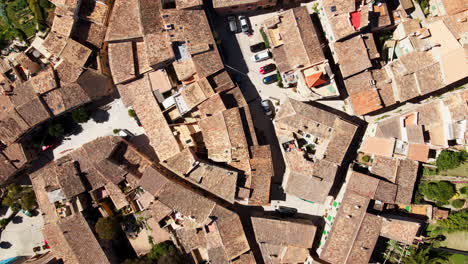 Top-down-aerial-pan-of-rooftops-in-traditional-village-of-Deia-Mallorca