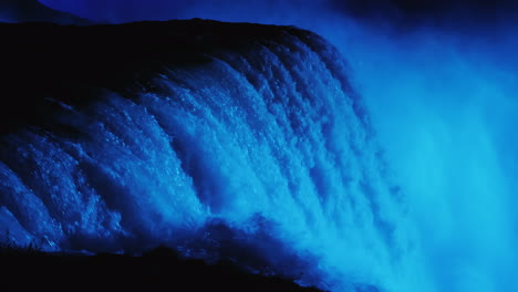 niagara falls lit up blue at night