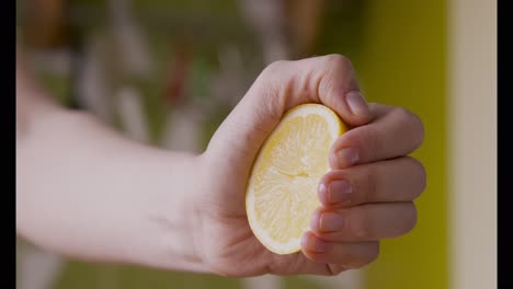 hand squeezing a lemon