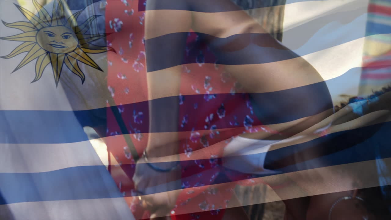 Dancing in colorful clothing, people with Uruguay flag animation in background