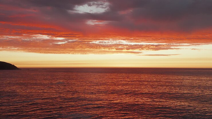 Dramatic Orange Sunset Sky Over Sea Horizon, Bakoven Beach, Cape Town In South Africa