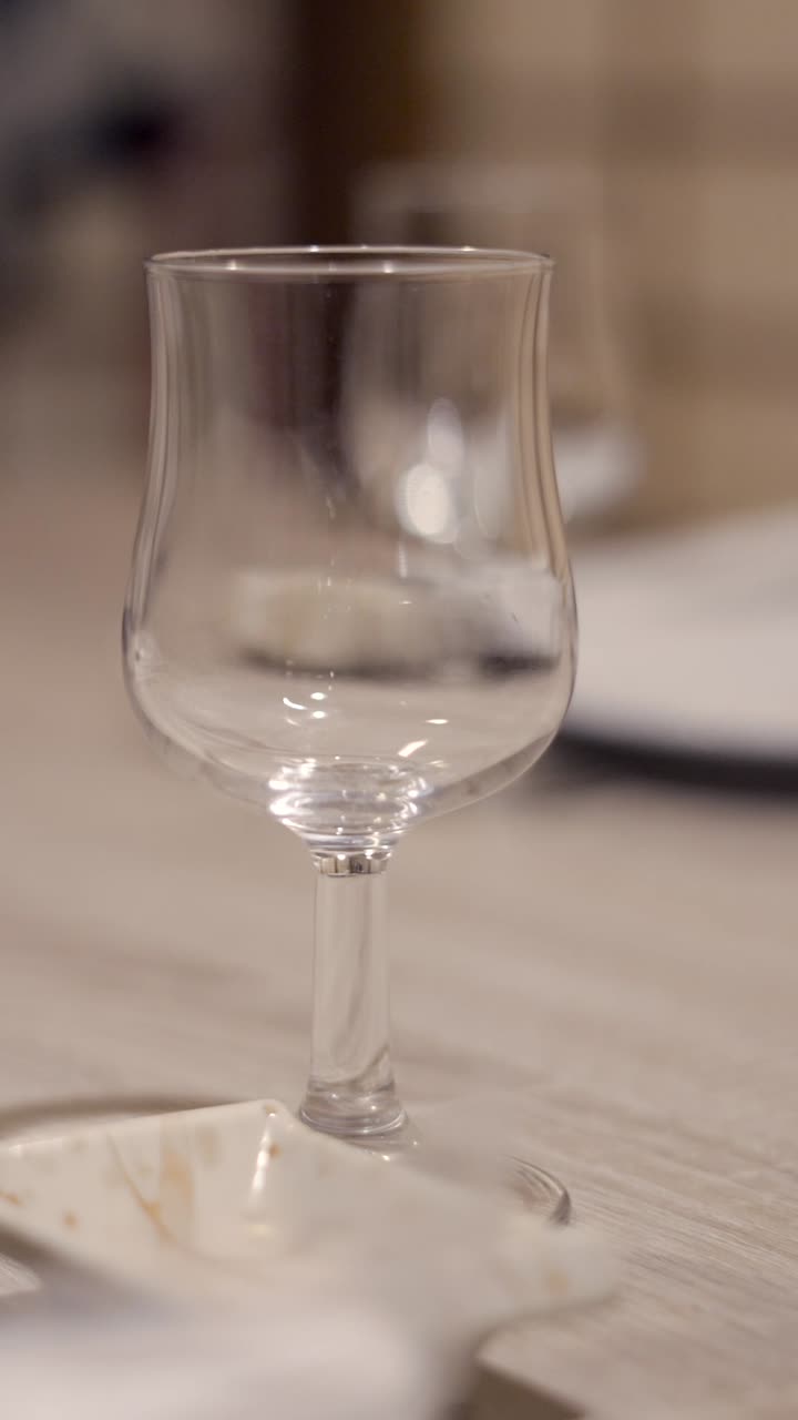 An empty stemmed glass on a table