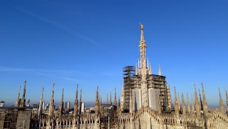 low angle aerial close up drone view of milan duomo cathedral revealing the cityscape