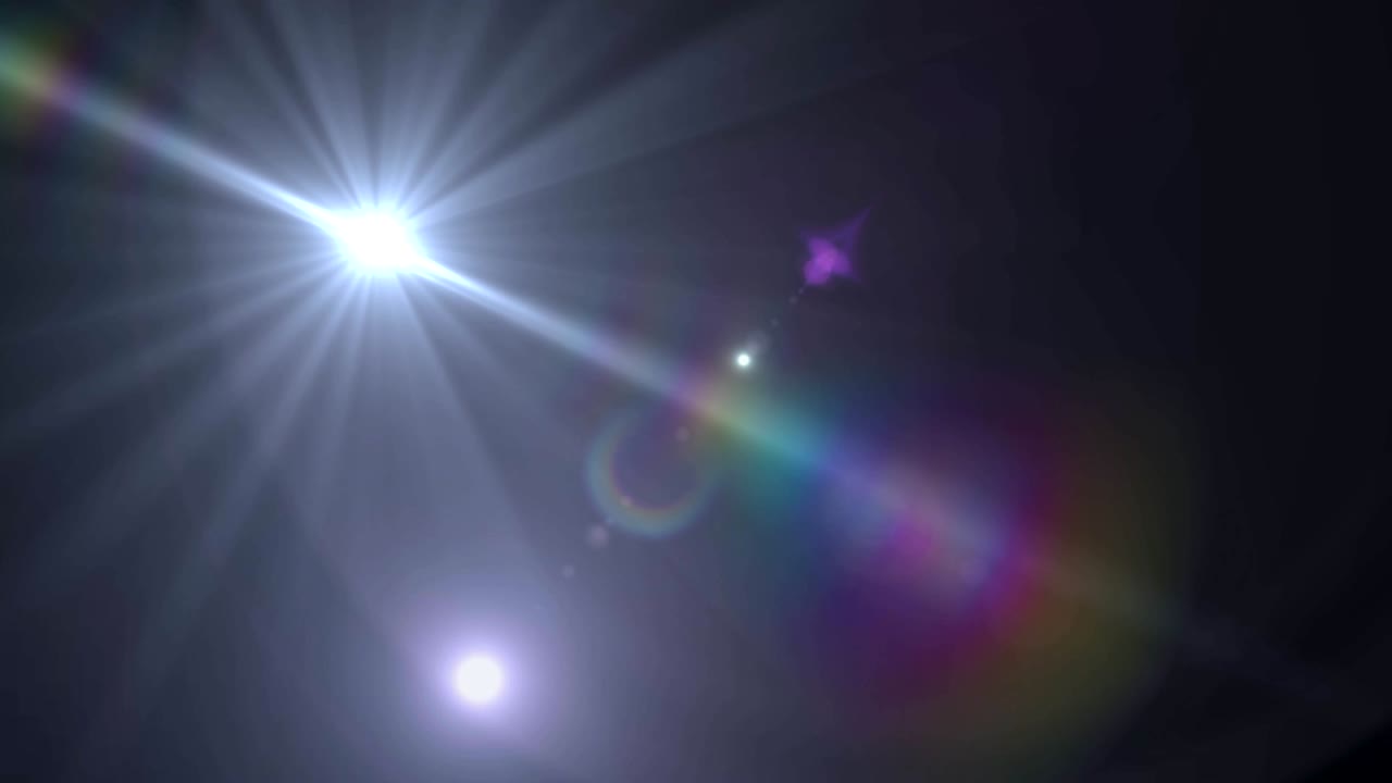 mancha de luz y destello de la lente contra un fondo negro