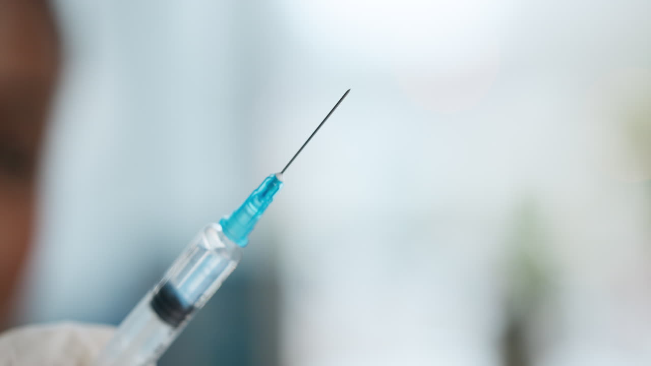 Close-up of a syringe with needle and vaccine