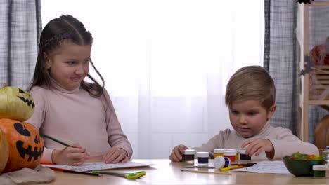 children painting halloween pumpkins