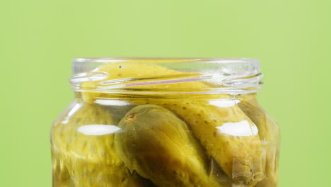 hand closing a jar of pickles