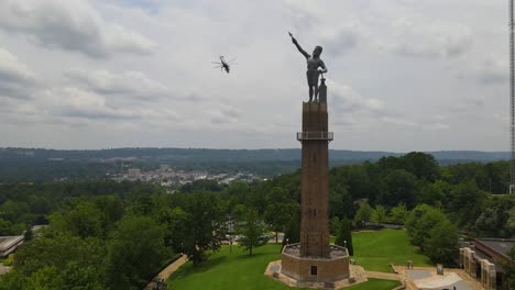 Helicopter-lifting-off-next-to-the-Vulcan-Statue-in-Birmingham,-Alabama