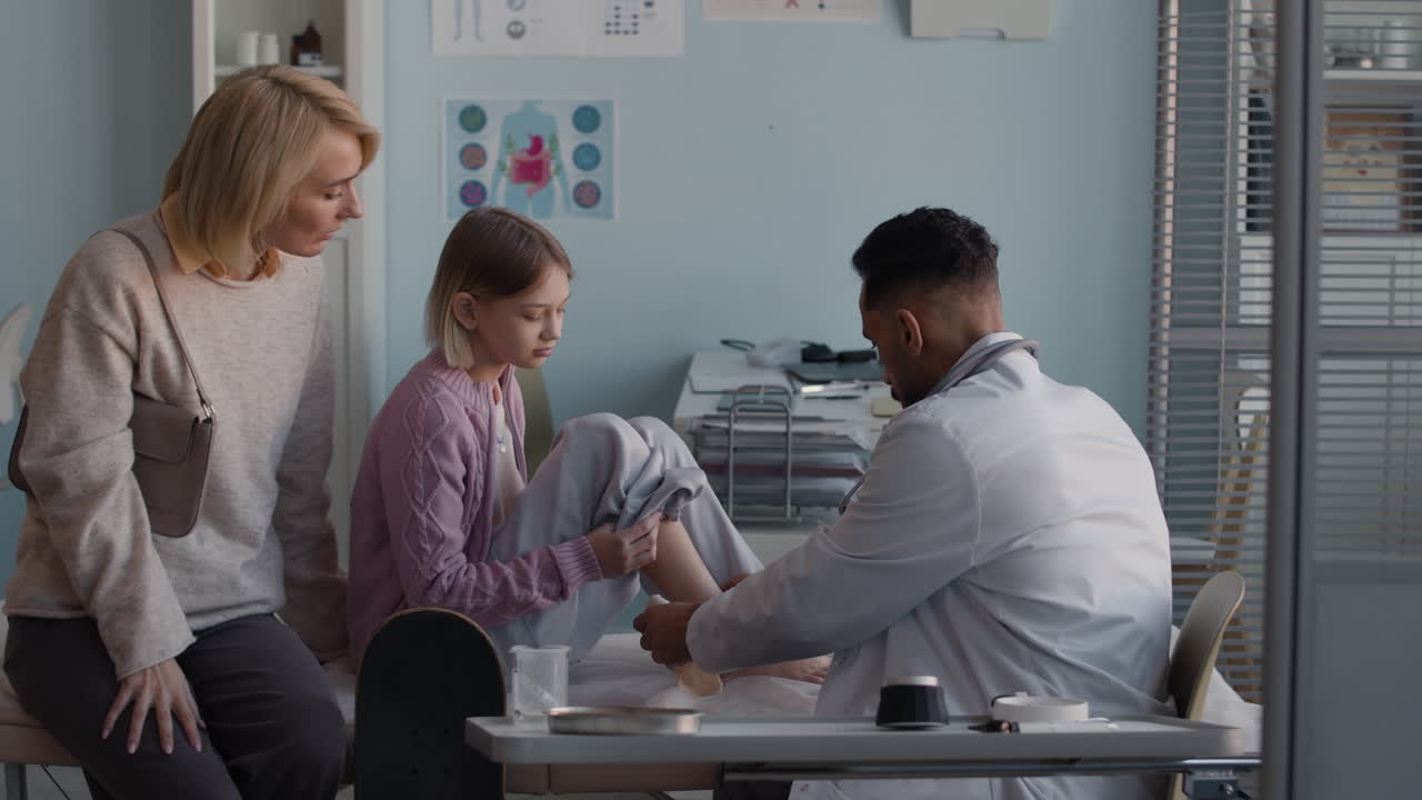 Doctor examining child with mother present