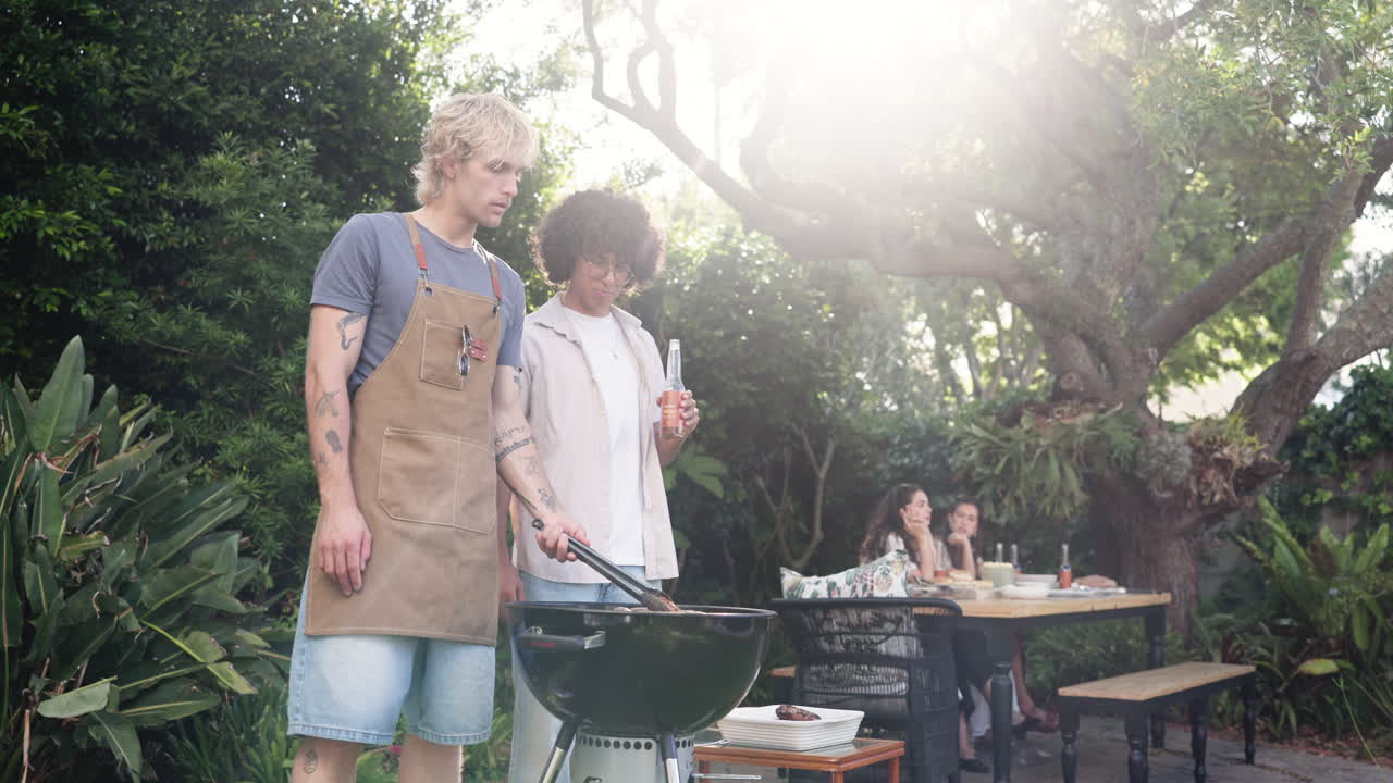 Young Men Grilling Barbecue for Friends in Sunny Backyard Garden