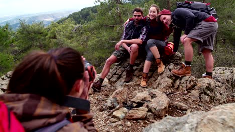 young hiker friends taking a photo on top of mountain