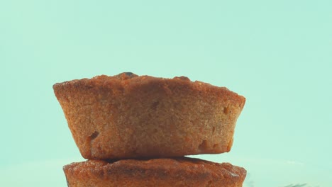 a close up shot of a plate with tasty cupcakes, on a 360 rotating stand, studio lighting, slow motion, 4k video