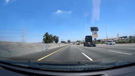 Lapso-De-Tiempo-De-Conducción-En-La-Autopista-Del-Sur-De-California-Con-Camiones-Grandes-En-Un-Día-Soleado