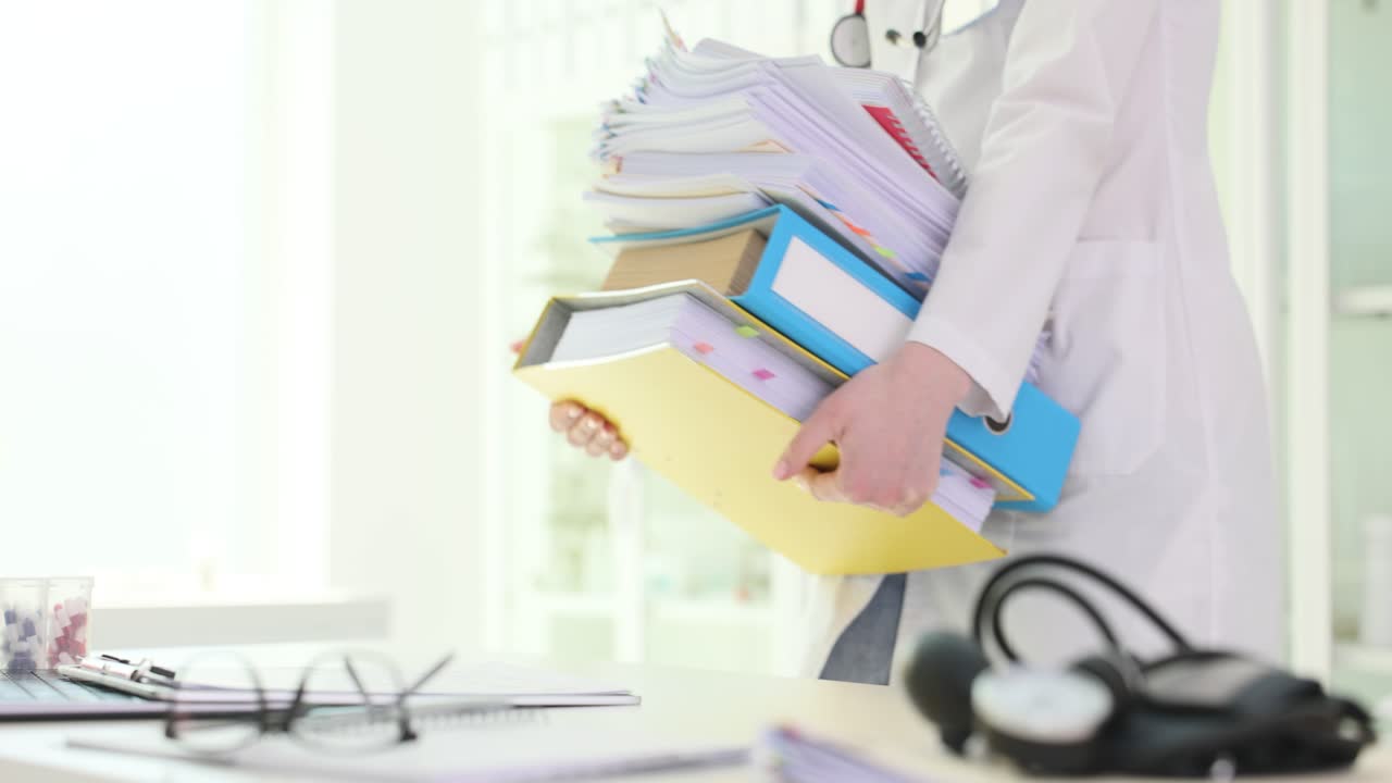 Doctor overwhelmed with paperwork