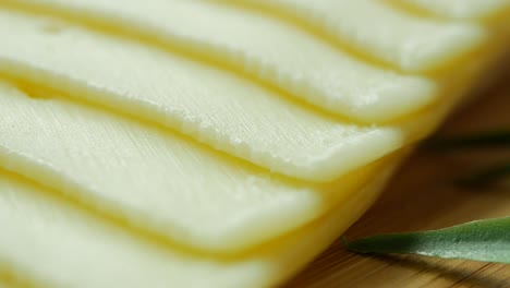 Mozzarella-slice-of-cheese-on-wooden-table-,