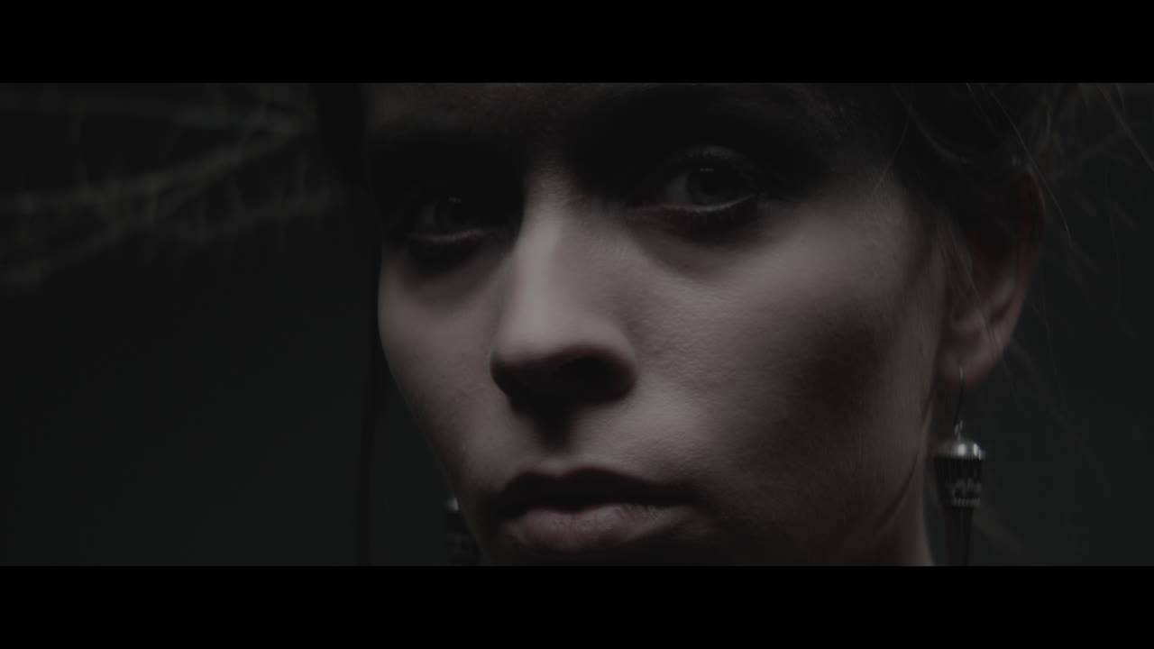 A woman dressed as mother nature turns her head and look into the camera