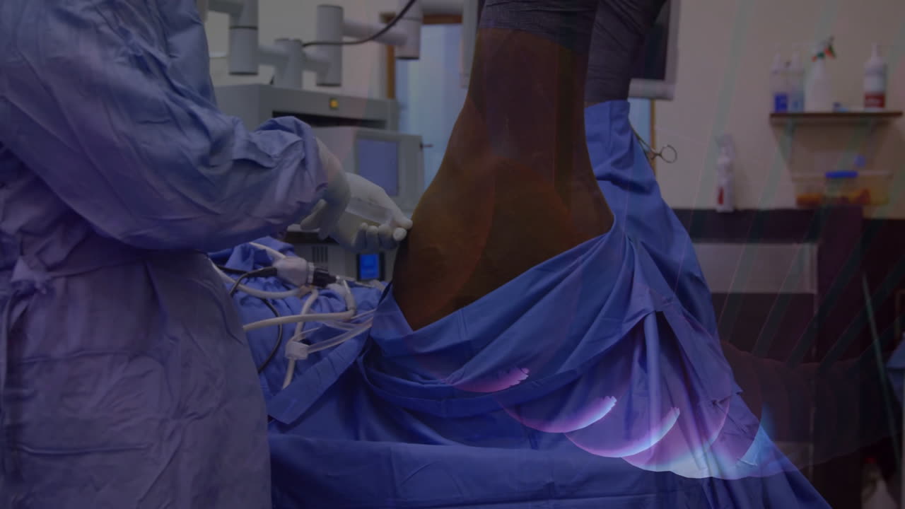 Surgeon operating patient leg under blue drape in hospital, showing animated vital sign graph