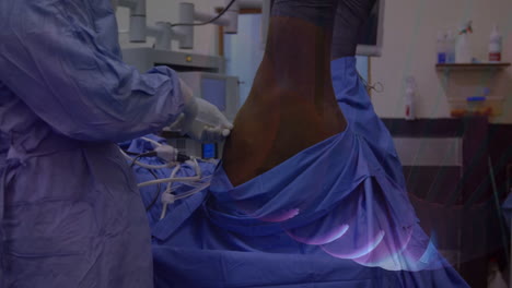 surgeon operating patient leg under blue drape in hospital, showing animated vital sign graph