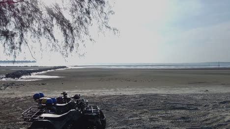 drone shot of atv on the beach in bagan lalang in morning, selangor, malaysia