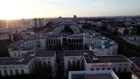 beautiful flyover of the city center of montpellier, france while a stunning sunset during golden hour