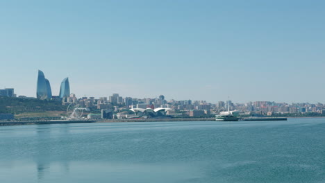 baku skyline at caspian sea with flame towers skyscraper - sunny day