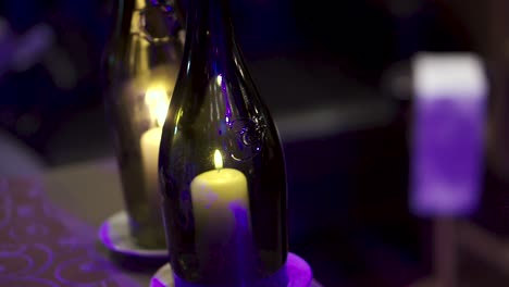 candles in wine bottles