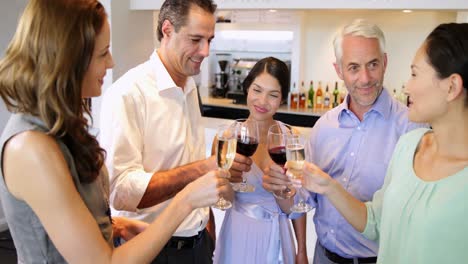 attractive friends chatting together and toasting their drinks