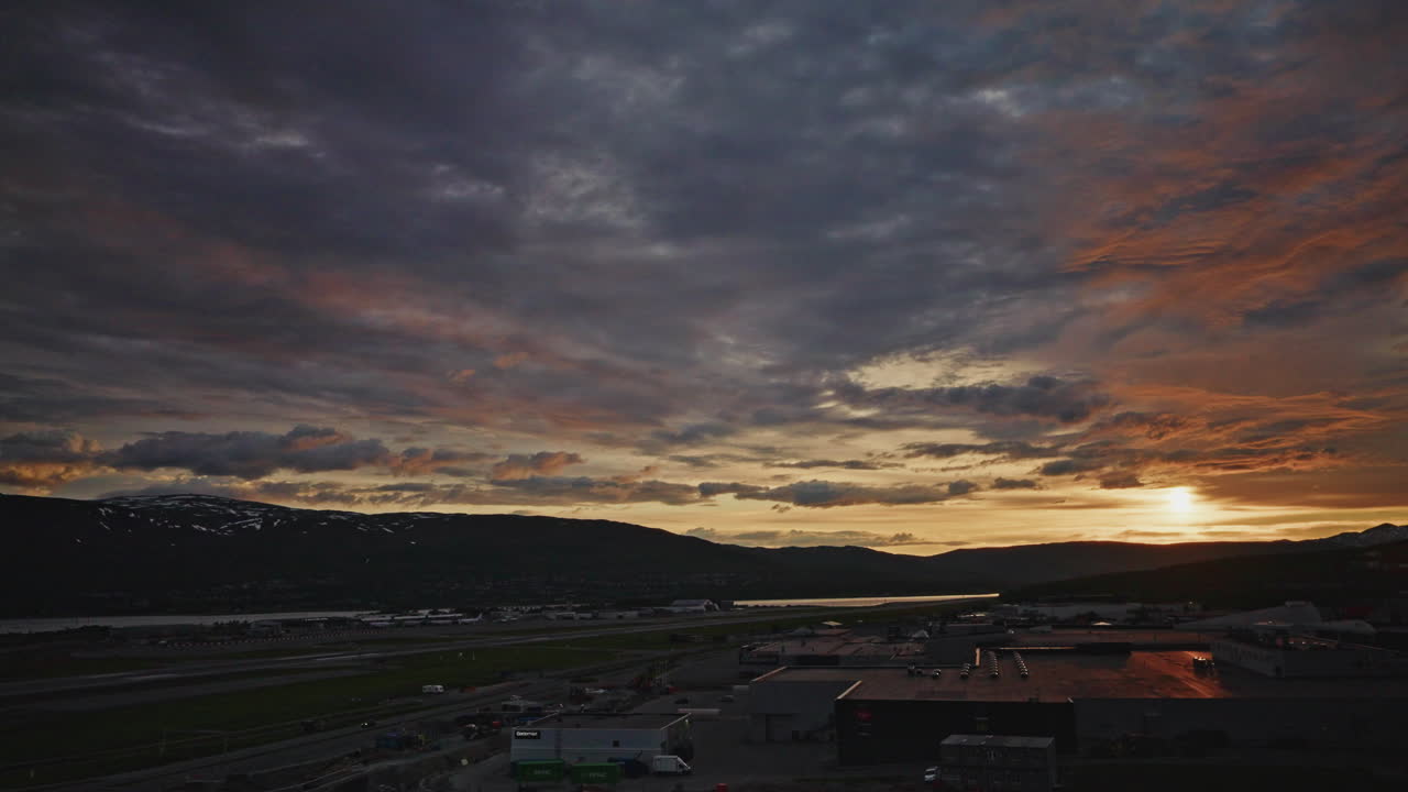 Midnight sunset over the Norwegian Fjords in Tromso.
Arctic golden hour twilight. Traveling clouds.