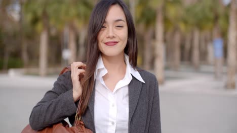 Gorgeous-young-woman-putting-purse-over-shoulder