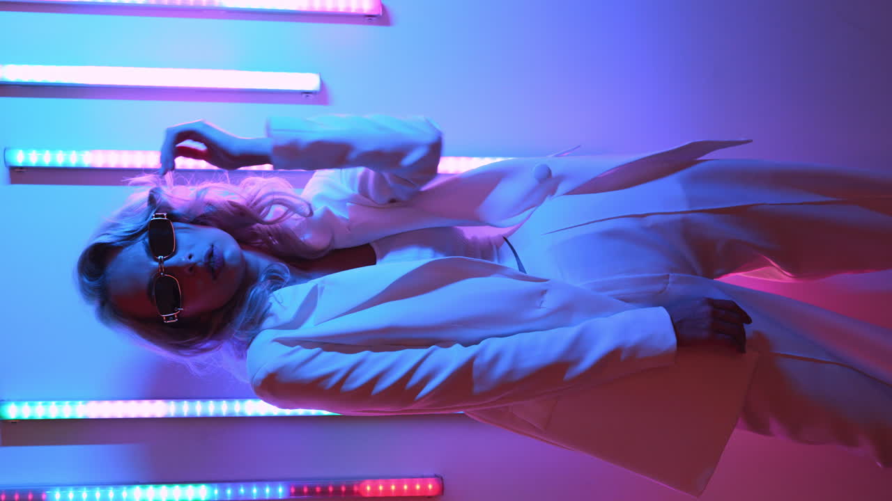 Stylish Woman in White Outfit with Neon Lights