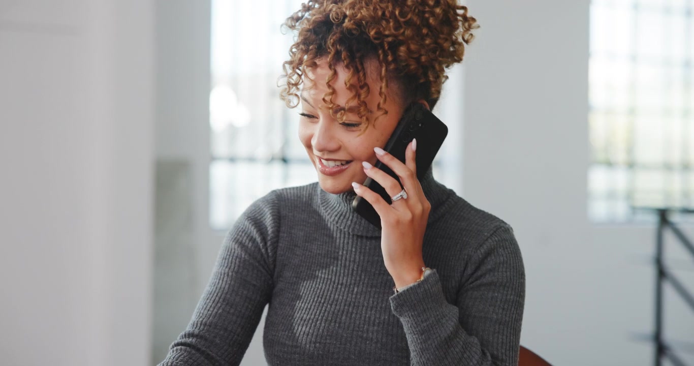 Young Woman Talking on Smartphone in Bright Modern Office