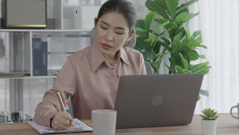 enthusiastic businesswoman working and typing laptop in the office.