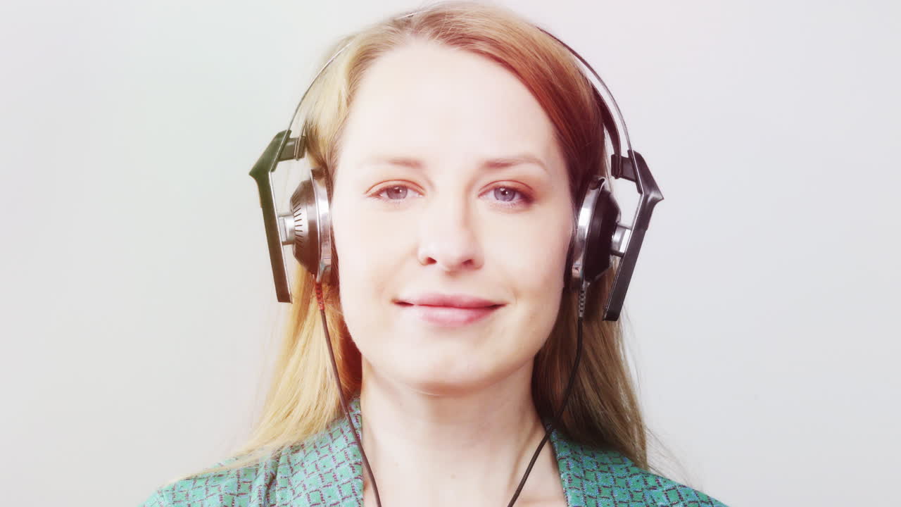 cool female dancer with changing retro headphones to listen to music