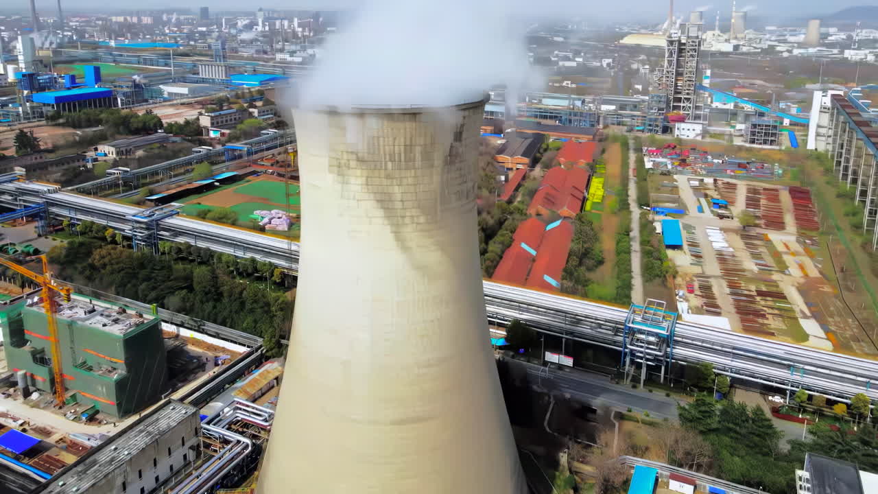 Aerial View of a Large Industrial Plant with a Cooling Tower