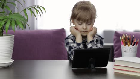 Girl-studying-online-homework-using-digital-tablet-computer.-Distance-education