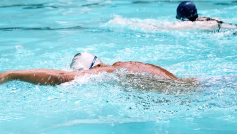 senior man swimming in pool