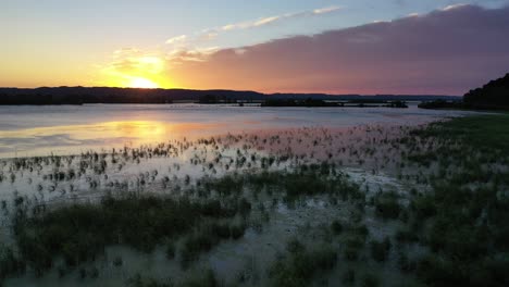 sunset over a calm lake with marsh