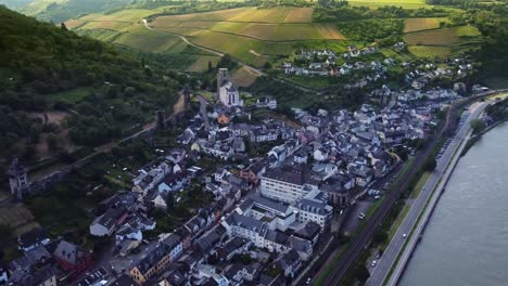 oberwesel town in rhine valley amid medieval fortifications and vineyards hills, aerial view